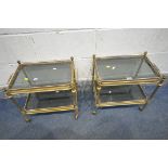 A PAIR OF MID CENTURY SMALL BRASS TROLLEYS, two trays with smoked glass inserts, length 50cm x depth