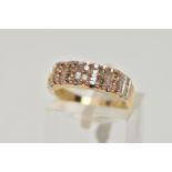 A 9CT GOLD, DIAMOND HALF ETERNITY RING, designed with five sections each set with two brown round