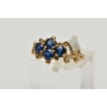 A 1970s 9CT GOLD SAPPHIRE DRESS RING, the circular cut sapphire quatrefoil panel, with openwork