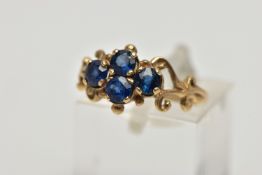 A 1970s 9CT GOLD SAPPHIRE DRESS RING, the circular cut sapphire quatrefoil panel, with openwork