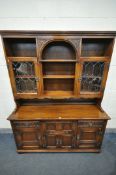 AN OLD CHARM OAK DRESSER, top with carved foliate arch, and two lead glazed doors, base with two