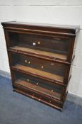 AN EARLY TO MID CENTURY OAK THREE TIER SECTIONAL BOOKCASE, with glazed hide and fall doors, width