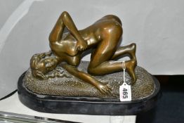 AN EROTIC BRONZE FIGURINE, of a young woman, marked Bronze on the base, on an oval black plinth,