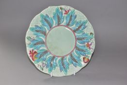 A CLARICE CLIFF 'LEAVES AND BERRIES' PATTERN PLATE, with a painted, relief moulded, wide border of