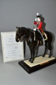 A COALPORT LIMITED EDITION 'TROOPING THE COLOUR' FIGURINE, depicting Her Majesty The Queen on