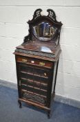 AN EARLY 20TH CENTURY MAHOGANY MUSIC CABINET, the raised back with open fretwork and bevelled