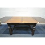 A 20TH CENTURY OAK DRAW LEAF DINING TABLE, on four legs united by a H stretcher, extended length