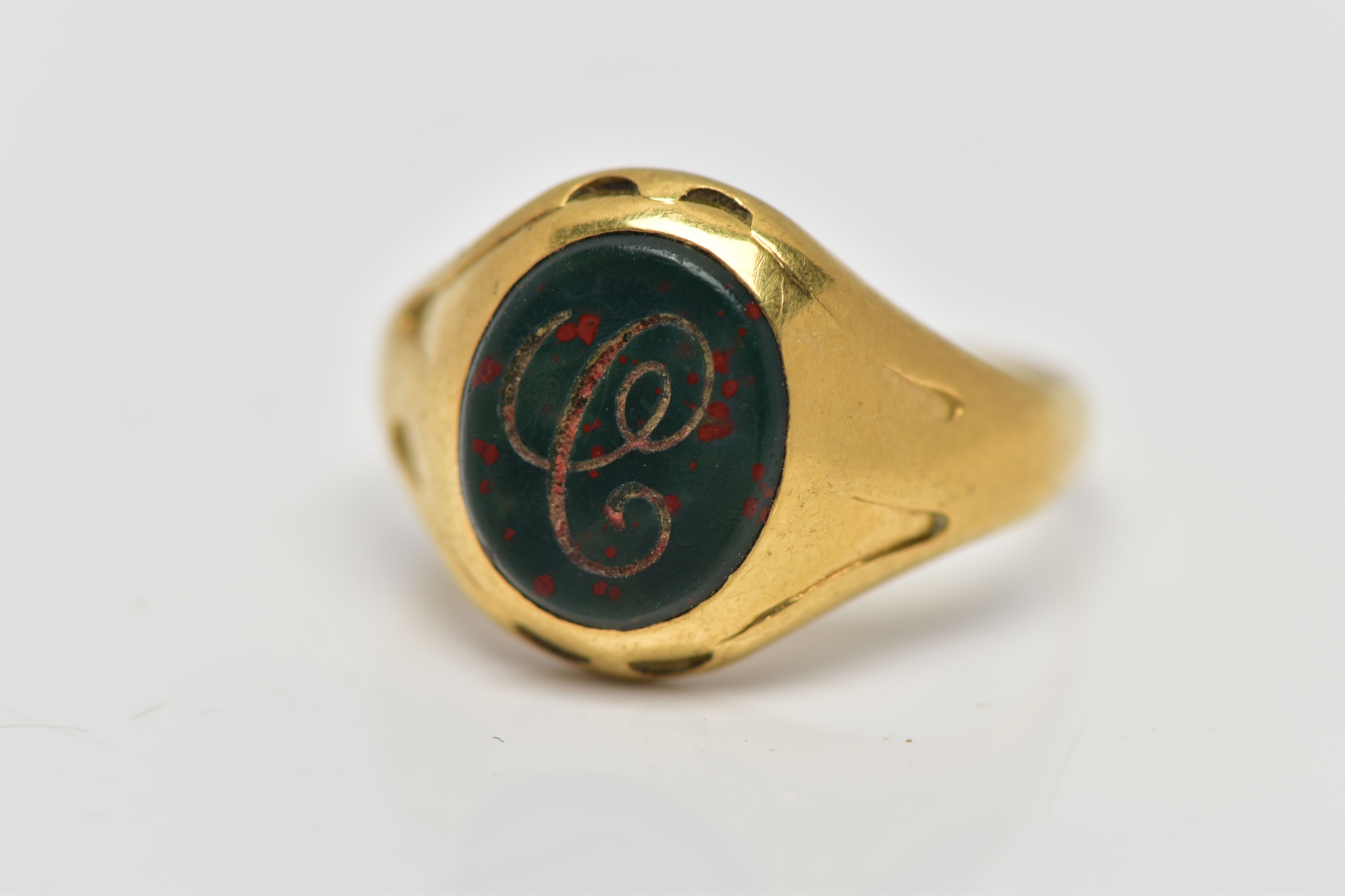 AN 18CT GOLD SIGNET RING, set with an oval bloodstone insert with an engraved initial 'C', worn