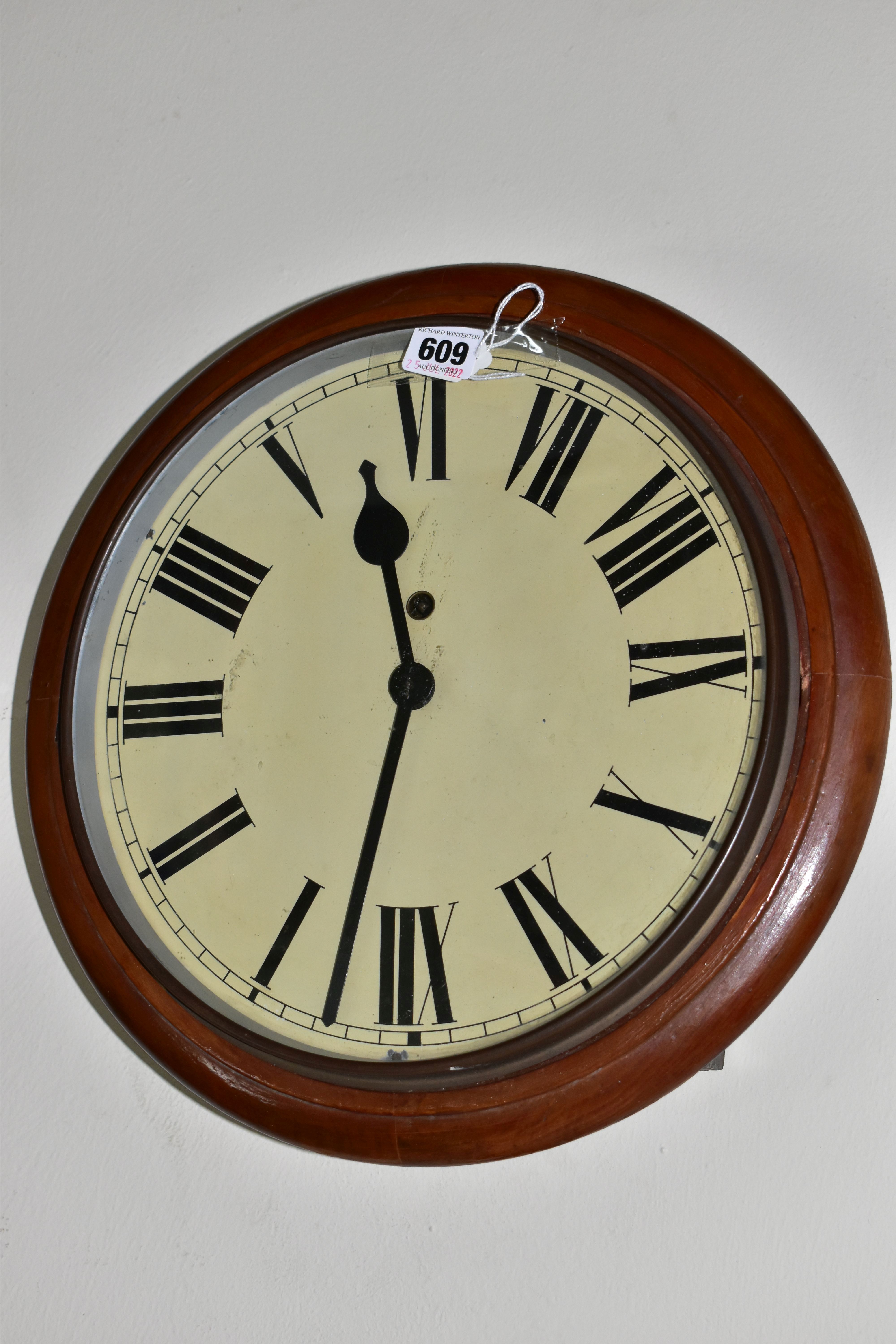 AN EARLY 20TH CENTURY CIRCULAR WALL CLOCK, 'train station style' with pendulum and key, Roman