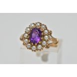 A 9CT GOLD AMETHYST AND SEED PEARL CLUSTER RING, the oval cut amethyst within claw setting to the