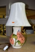 A MOORCROFT POTTERY TABLE LAMP BASE DECORATED WITH A CORAL 'HIBISCUS' DESIGN ON A CREAM