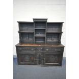 A 19TH CENTURY CARVED OAK DRESSER, the top with an arrangement of open shelves, over a base with