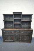 A 19TH CENTURY CARVED OAK DRESSER, the top with an arrangement of open shelves, over a base with