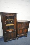 AN OAK DRINKS CABINET with mirrored interior, above double cupboard doors, and single drawer,