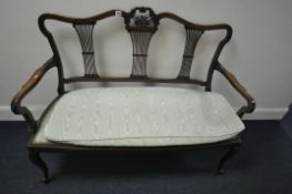 AN EDWARDIAN MAHOGANY SOFA, with a carved cresting, triple pierced splat back, open armrests, on