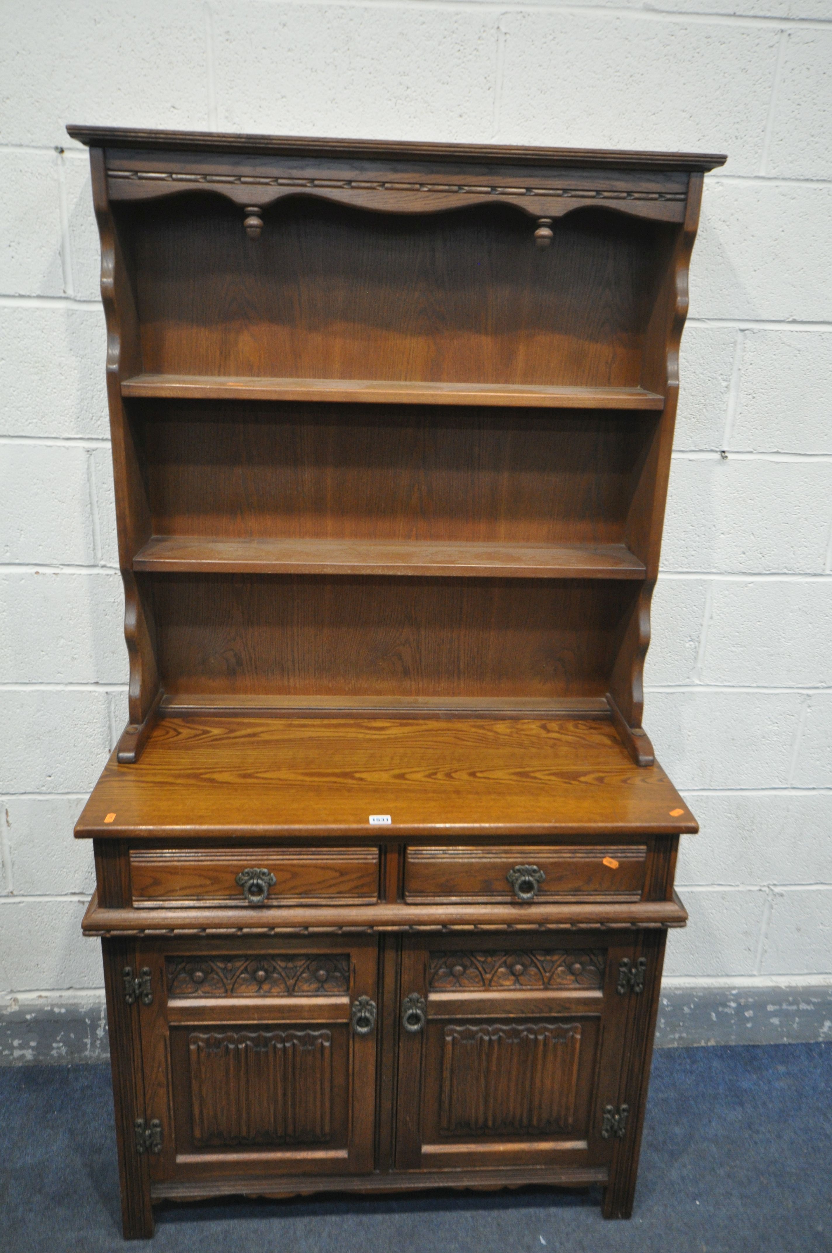 AN OLD CHARM DRESSER, top with two tier plate rack, base with two drawers over two cupboard doors,