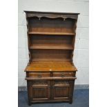 AN OLD CHARM DRESSER, top with two tier plate rack, base with two drawers over two cupboard doors,