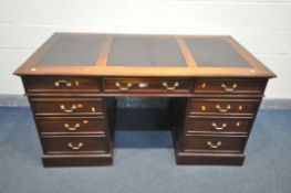 A HARDWOOD PEDESTAL DESK, with triple black leatherette writing surface, and an arrangement of