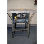 A TITAN SF10N1 10in TABLE SAW on stand with blade along with a Black and Decker 700 workmate and
