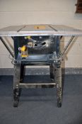 A TITAN SF10N1 10in TABLE SAW on stand with blade along with a Black and Decker 700 workmate and