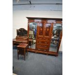 AN EDWARDIAN MAHOGANY THREE PIECE BEDROOM SUITE, comprising a compactum wardrobe with two bevelled