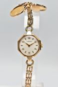 A GARRARD 9CT GOLD MANUAL WIND WRISTWATCH TOGETHER WITH TWO MOUNTED 1/10 OZ KRUGERRAND COINS, the
