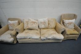A WICKER SIX PIECE CONSERVATORY SUITE, comprising a three seater sofa, two various armchairs, a