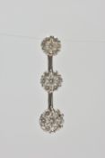 A 9CT WHITE GOLD DIAMOND CLUSTER PENDANT, comprising of three graduated brilliant cut diamond floral