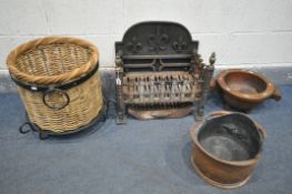 A CAST IRON FIRE GRATE, a circular wicker log basket, on a wrought iron base, a hardwood pestle, and