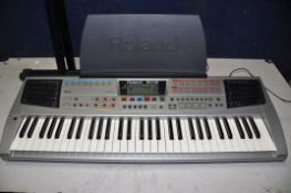 A ROLAND EM-15 ELECTRIC KEYBOARD with sheet music holder and keyboard stand (PAT pass and working)