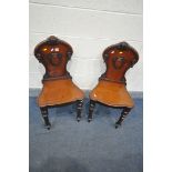 A PAIR OF REGENCY MAHOGANY HALL CHAIRS, with scrolled back surrounding a shield (condition:-solid