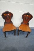 A PAIR OF REGENCY MAHOGANY HALL CHAIRS, with scrolled back surrounding a shield (condition:-solid