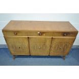 A MID CENTURY WALNUT SIDEBOARD, with three drawers above three cupboard doors, length 135cm x