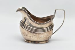 A GEORGE III SILVER MILK JUG, designed with ribbed banding, to the plain base, with monogram