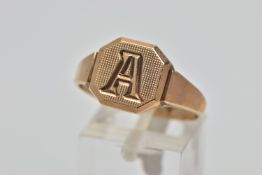 A 9CT GOLD SIGNET RING, square signet with cut off corners, engine turned design with engraved