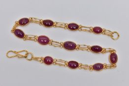 A YELLOW METAL AND RUBY SPECTACLE SET BRACELET, comprised of twelve slightly graduated oval cabochon
