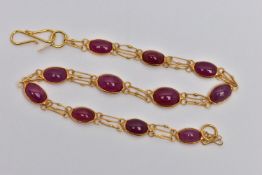 A YELLOW METAL AND RUBY SPECTACLE SET BRACELET, comprised of eleven slightly graduated oval cabochon