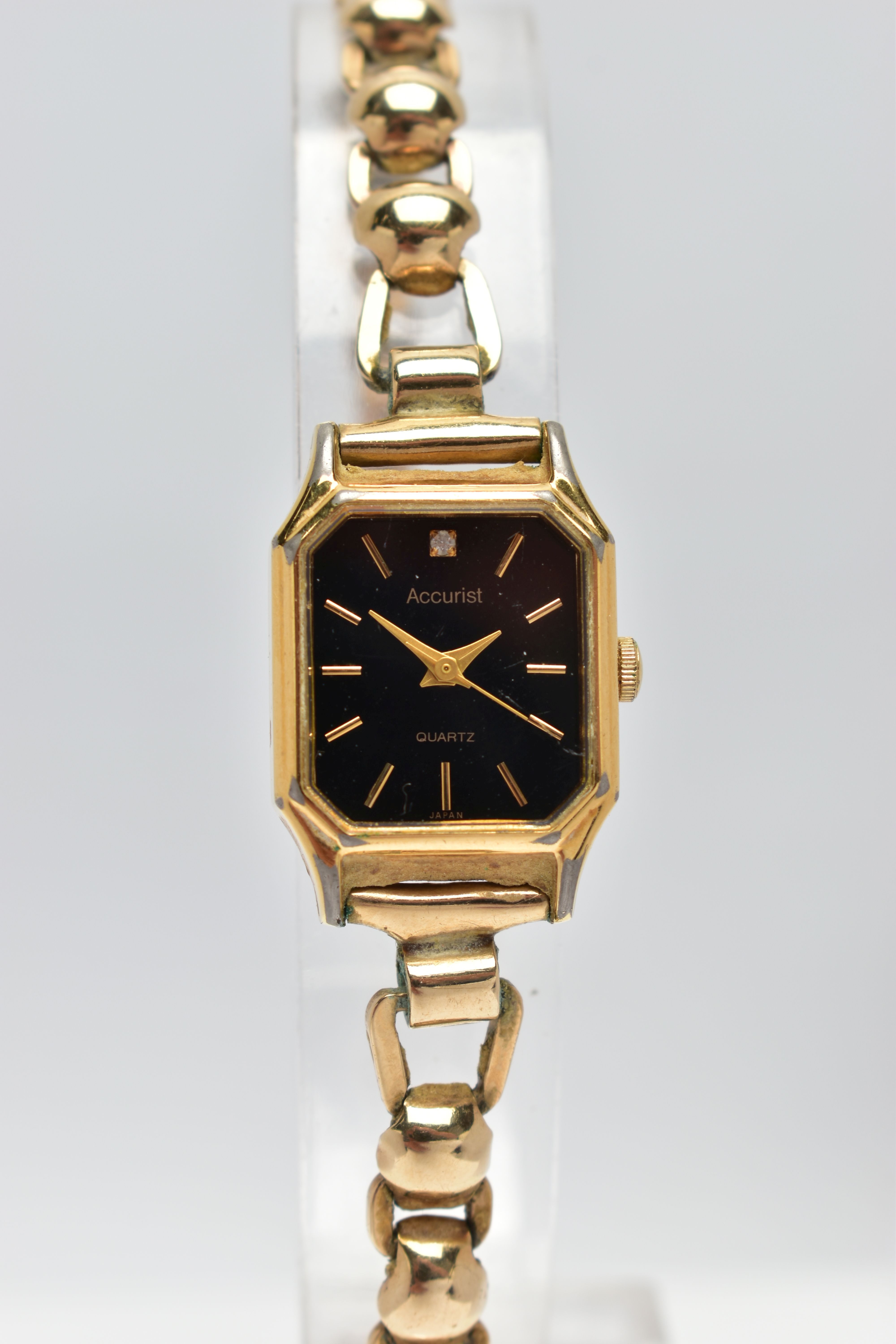 A LADIES 1950's 'ACCURIST' WRISTWATCH WITH 9CT GOLD STRAP, the octagonal black dial, signed '