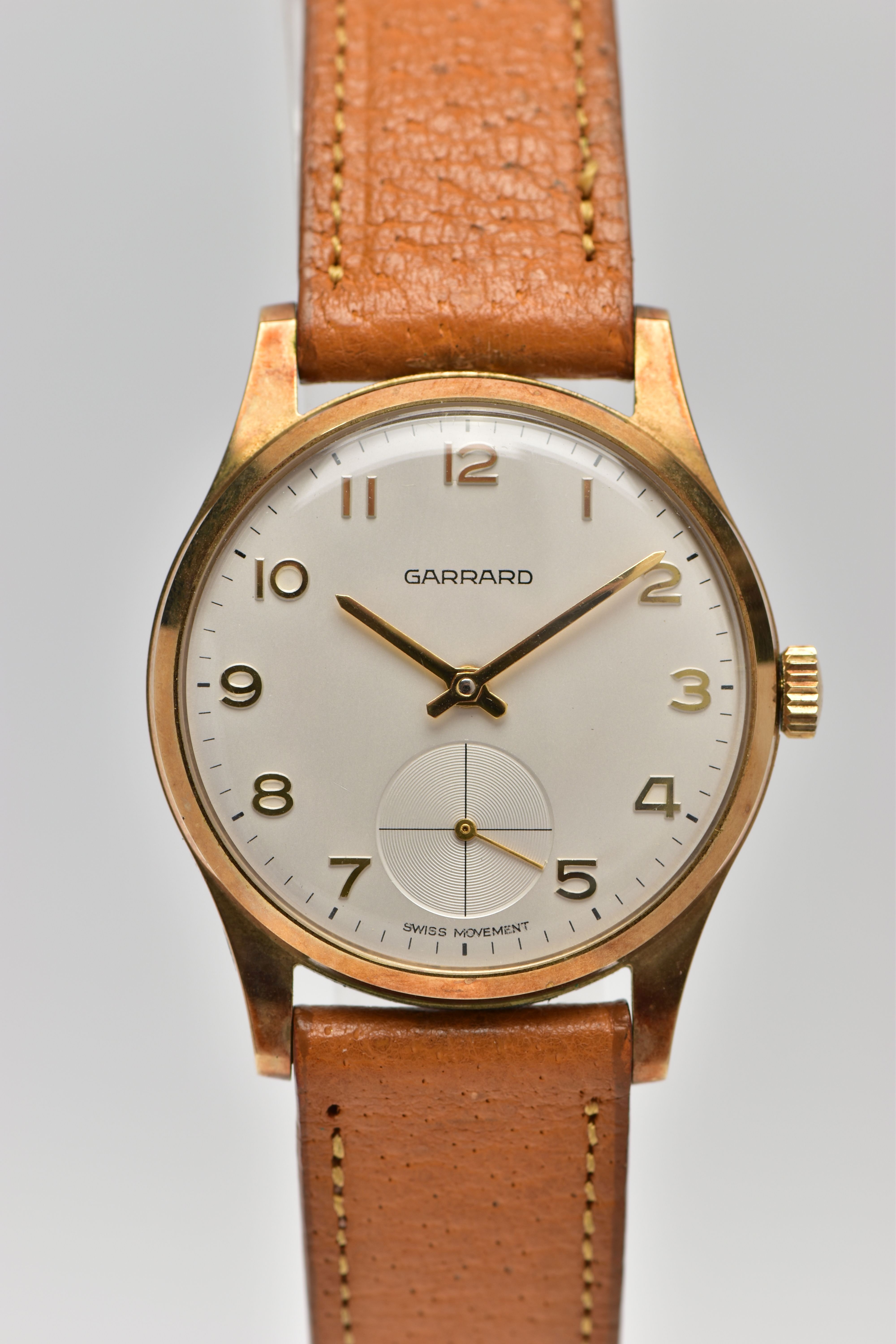 A 9CT GOLD 'GARRARD' WRISTWATCH, hand wound movement, round white dial signed 'Garrard' 'Swiss