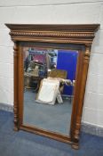 A 20TH CENTURY FRENCH WALNUT BEVELLED EDGE OVERMANTEL MIRROR, with fluted columns, width 99cm x