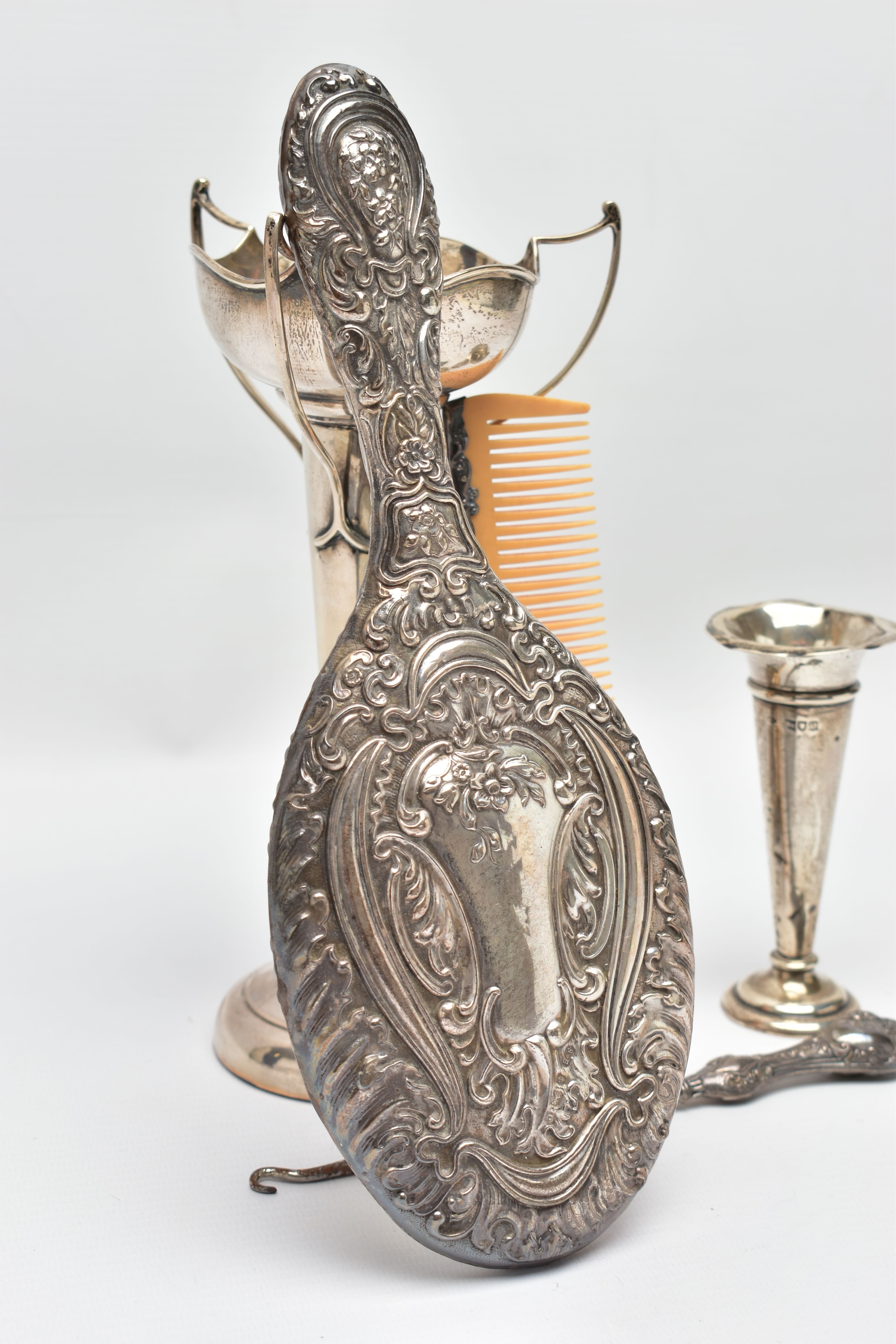 A SELECTION OF EARLY TO MID 20TH CENTURY SILVER, to include a scroll and floral embossed hand - Image 4 of 6