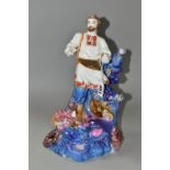 A KIEV PORCELAIN FIGURE OF 'SADKO', a folk tale adventurer and musician, playing music to the Sea