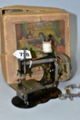 A VINTAGE GERMAN CHILDS SEWING MACHINE WITH BOX, appears to be complete and working, box tatty