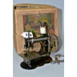 A VINTAGE GERMAN CHILDS SEWING MACHINE WITH BOX, appears to be complete and working, box tatty