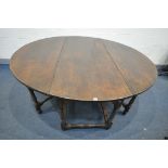 A LARGE REPRODUCTION GEORGIAN STYLE OAK GATE LEG TABLE, the drop leaves each with double legs,