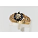 A 9CT GOLD DIAMOND AND SAPPHIRE CLUSTER RING, the illusion set single cut diamond, within a circular