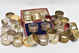 AN ASSORTMENT OF WHITE METAL NAPKIN RINGS, to include a pair of cased napkin rings pierced