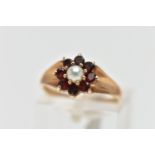 A 9CT GOLD CULTURED PEARL AND GARNET CLUSTER RING, the claw set cultured pearl, with circular cut