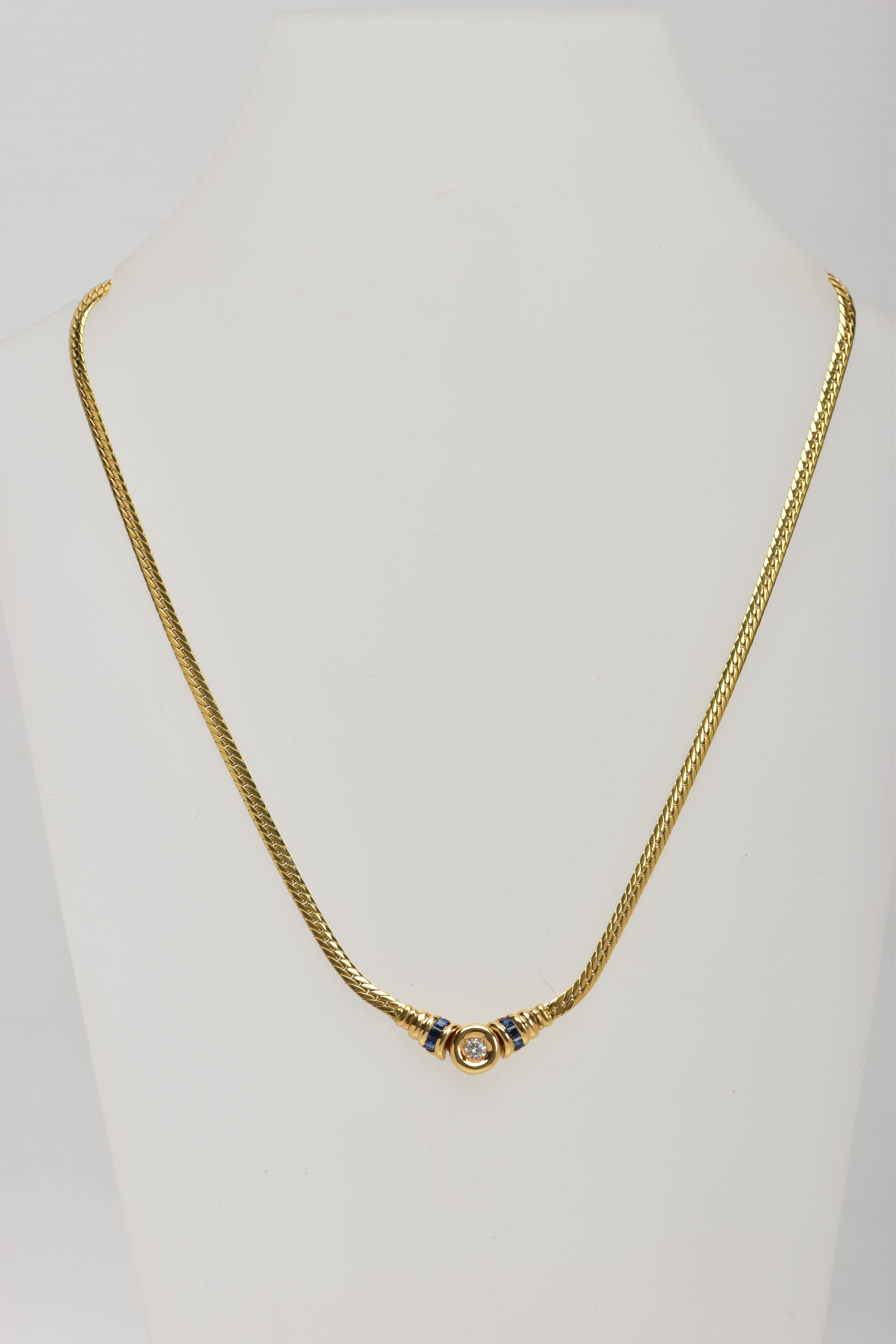 A YELLOW METAL DIAMOND AND SAPPHIRE NECKLACE, an articulated flat link chain fitted with a claw - Image 2 of 4