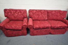 A BEIGE UPHOLSTERED TWO PIECE SUITE, comprising a two seater sofa and an armchair, both with red